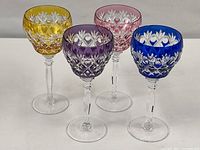 Front view of all four colored crystal wine glasses