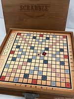 Open wooden case showing full Scrabble board