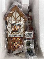 Porcelain building sealed in plastic inside Styrofoam insert