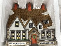 Front view of porcelain boarding school building showing details and signage