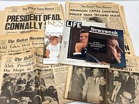 Stacks of Dallas newspapers plus three Kennedy magazines/books