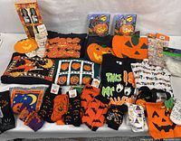 Overview of all Halloween clothing, socks, treat bags, ceramic ghosts, plush bucket
