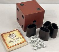 Full set showing storage box, four cups, dice, pouch and instructions