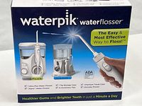 Front of sealed Waterpik box showing images of Ultra Plus and Nano units