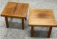 pair of matching square wooden tables top views