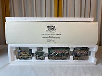 Box lid showing Heritage Village Collection branding and set information