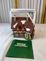 Front view of porcelain building with Styrofoam insert and pamphlet