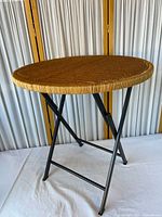 Full view of round woven-top folding table