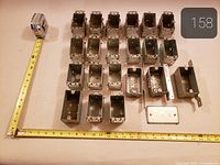 All electrical boxes and plates arranged with measuring tapes for scale