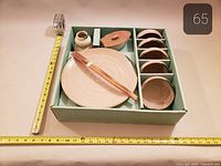 Boxed set with all items stacked, measuring tape for scale