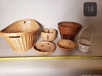 all six baskets lined up with measuring tape for scale