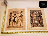 Both papyrus artworks with tape measure for scale