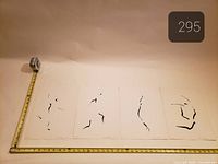 All four prints laid out with tape for scale