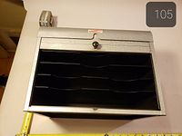 Cabinet top view open showing five black trays and measuring tape indicating width