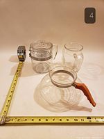 All three glass items with measuring tape for scale