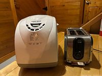 Breadmaker and toaster side by side showing overall condition