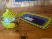 Bud vase and fused glass tray on table