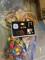 Bag with floss bobbins, hoops, booklet visible