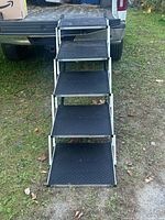 Stairs deployed against truck tailgate showing full five steps