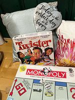 Monopoly box, Twister box, heart sign, blue pillow, white burst pillow visible