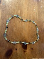 Necklace laid in oval showing bead pattern and clasp