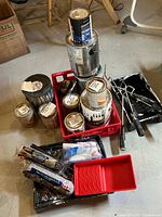 Overall view of all paint cans, trays, rollers and accessories