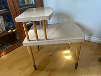 Full view of two-tier step end table showing veneer surfaces and tapered legs