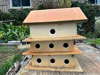 Front view showing three tiers and multiple round entrance holes