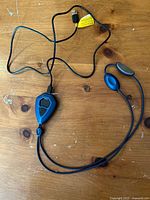 Entire neck massager showing USB cable, control unit and electrode leads