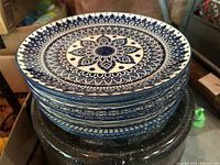 Stack of eight blue and white mandala dinner plates
