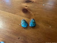 Front view of both teardrop turquoise stud earrings