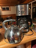 Coffee maker and kettle on tabletop