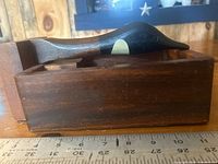 Side view showing duck-head lever and hardwood base