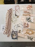 All necklaces laid out with pocket watch boxed, colour variety visible