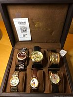 All six watches in display case