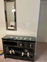 Front view of cabinet and mirror showing overall style and condition