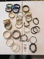 All bracelets laid out showing variety of materials and colours