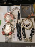 Table view of all eight necklaces showing variety and packaging