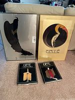 Front view of both framed posters and two closed books