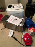 Group shot showing bread maker, toaster, waffle maker, mini griddle and egg peeler