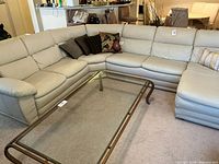 Full view of sectional sofa with throw pillows, showing upholstery color and condition