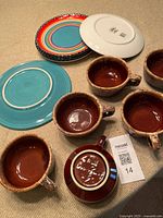 Overview of all mugs, turquoise plate, stack of rainbow plates