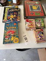 Overall view of binder, four boxed packs, three books on table