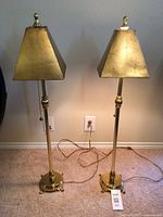 Front view of both brass table lamps with pyramid shades