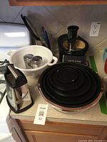 Overall lot showing nested mixing bowls with lids, colander, cheese grater, electric mandoline