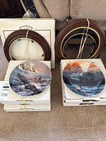 Two plates with frames and boxes on carpet