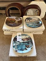 Three plates displayed, four boxes, wood frames visible