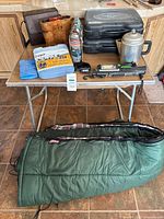 Overall lot on table showing all items including sleeping bag