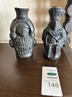 Both Indigenous figure vases side by side