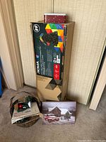 Box of Noma Christmas tree with tin, wall print and lights visible